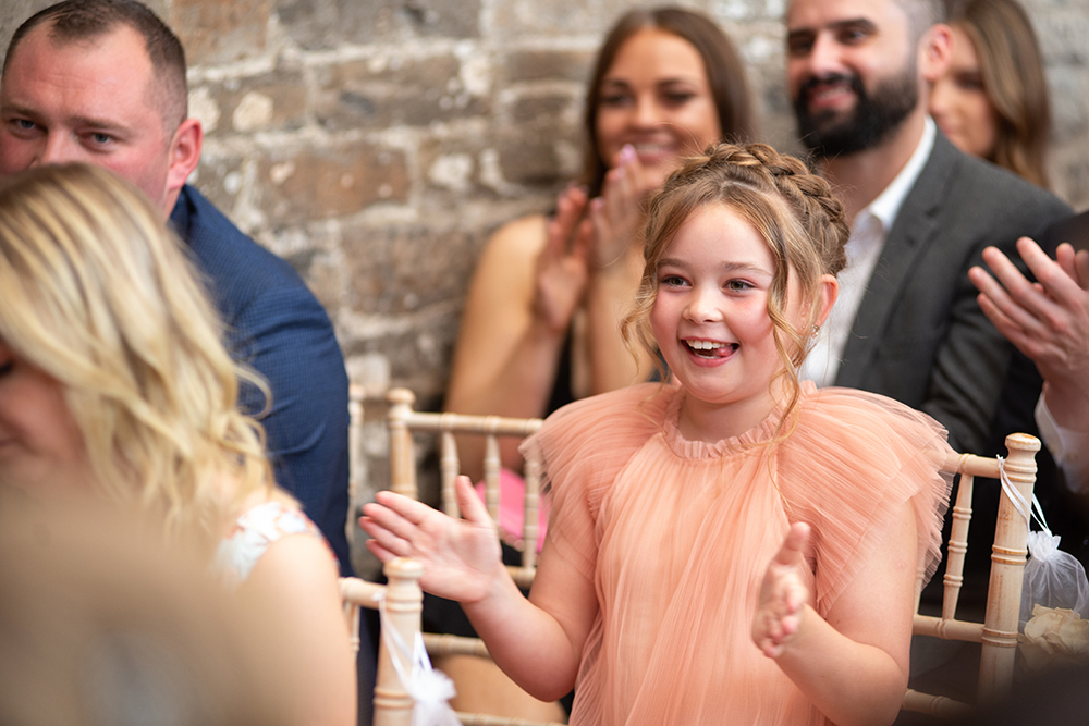 Young girl in peach dress clapping