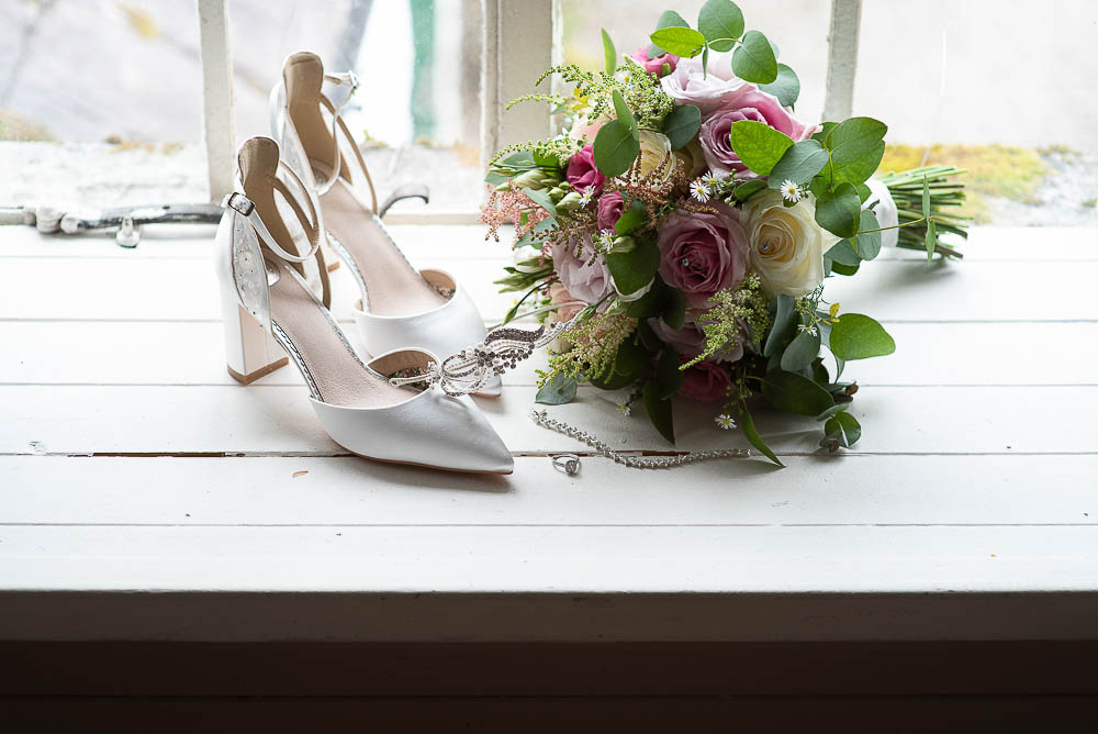 Wedding day shoes and flowers at wedding at Rathsallah