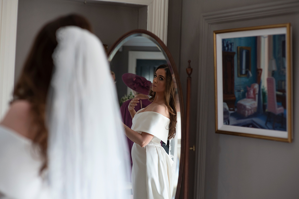 bride looking at herself at wedding at Clonabreany House