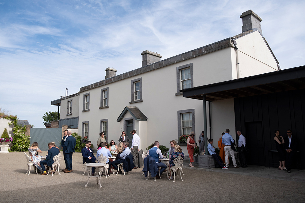 guests enjoying drinks outside at Summer wedding at Clonabreany House