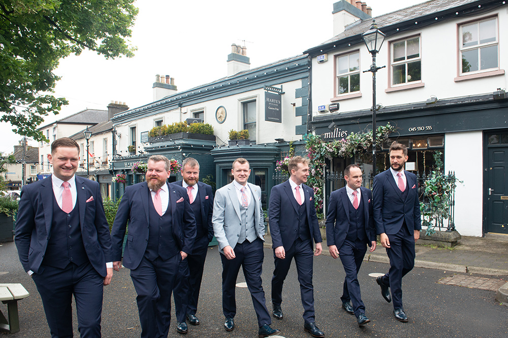 Groomsmen take a stroll before their wedding at Glasson