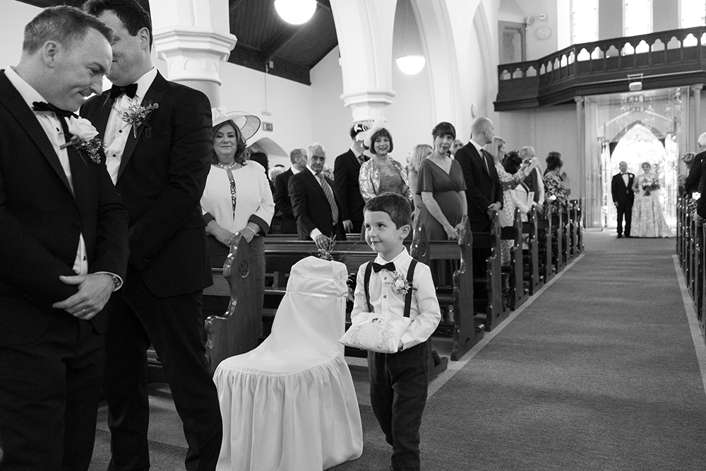 black and white documentary wedding photographer shooting in Church of the Nativity Keadew