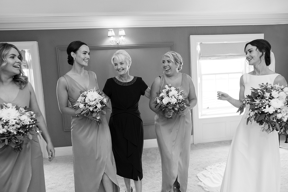 bridesmaids and mother of bride enjoy a joke at wedding at Clonabreany House