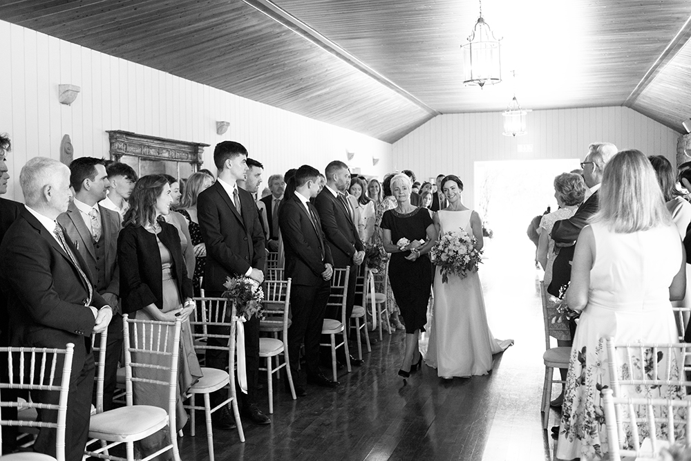 bride comes down aisle at wedding at Clonabreany House