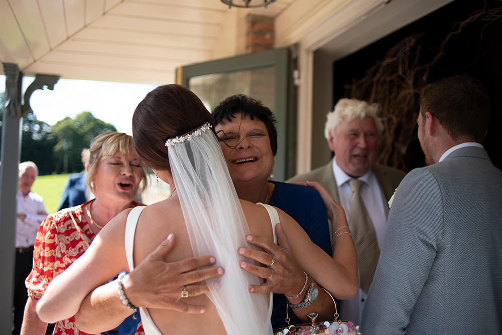 guests hugging each other outside the grounds at Clonabreany House wedding