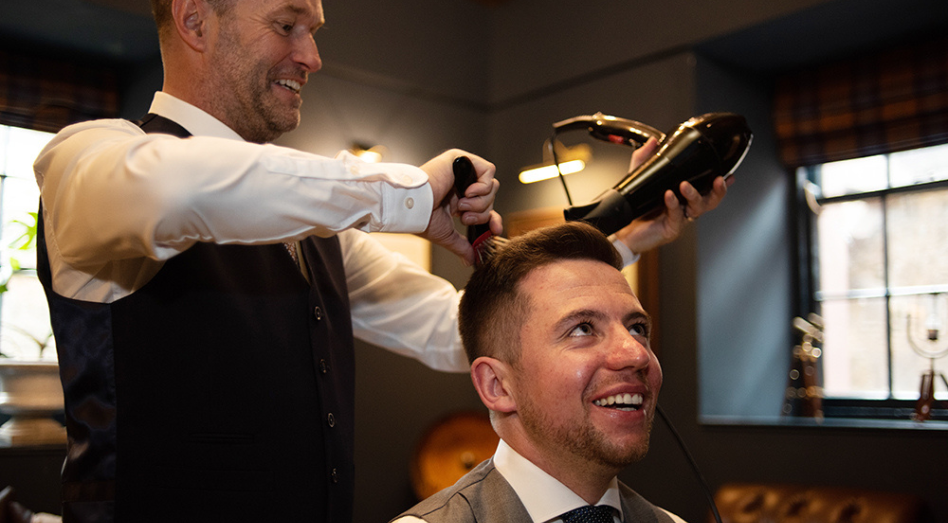 Groom smiling while getting hair done