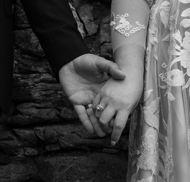 Mallory & Tommie holding hands black and white