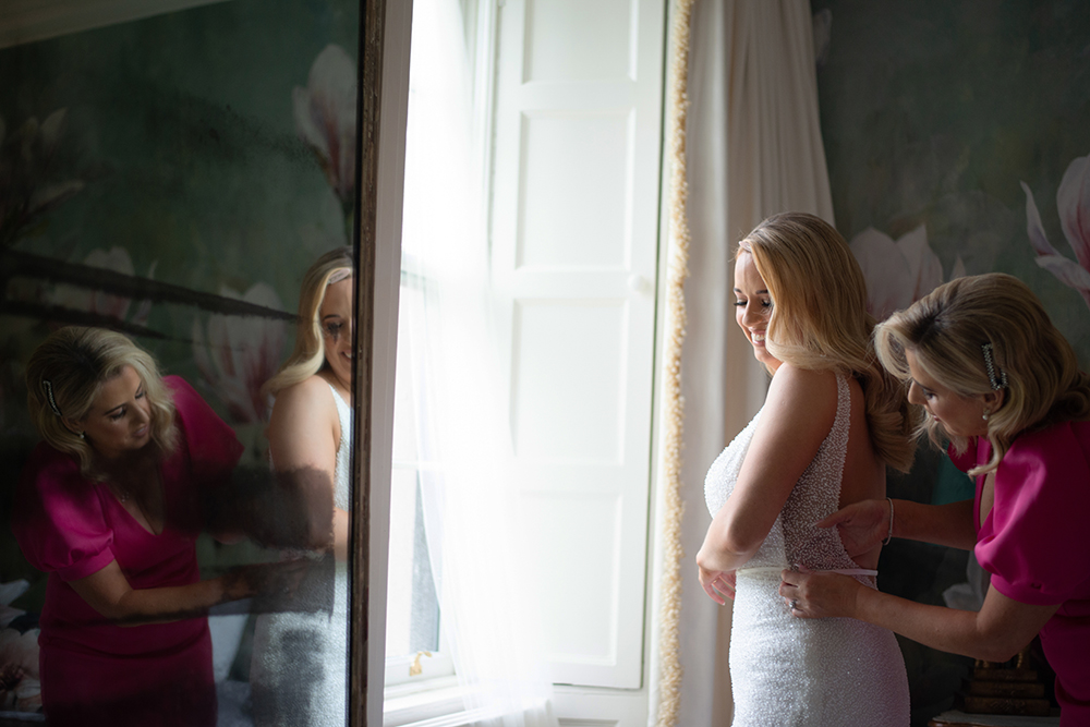 Bride finishing her last minute touch ups before wedding at Boyne Hill House