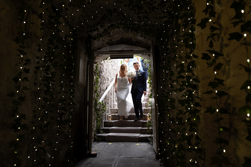 coming through the fairy lights at wedding at Boyne Hill House