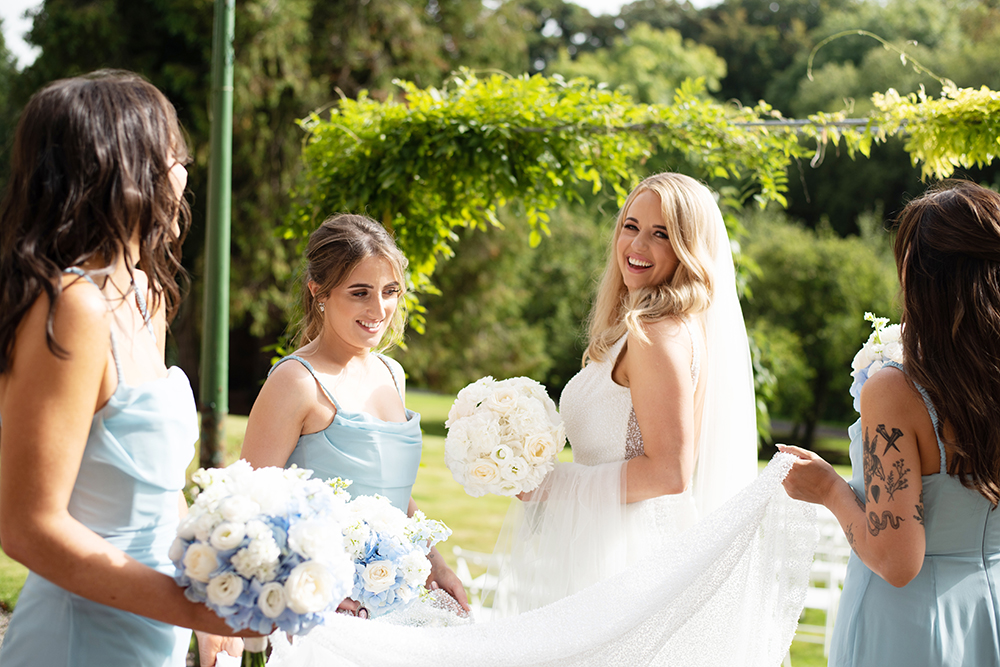 Bride and her bridesmaids having fun in gardens at Boyne Hill House