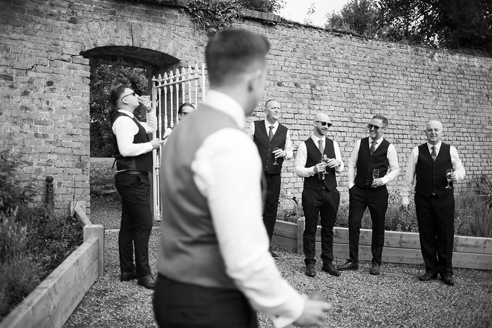 Groosmen and Groom in black and white at wedding Boyne Hill House