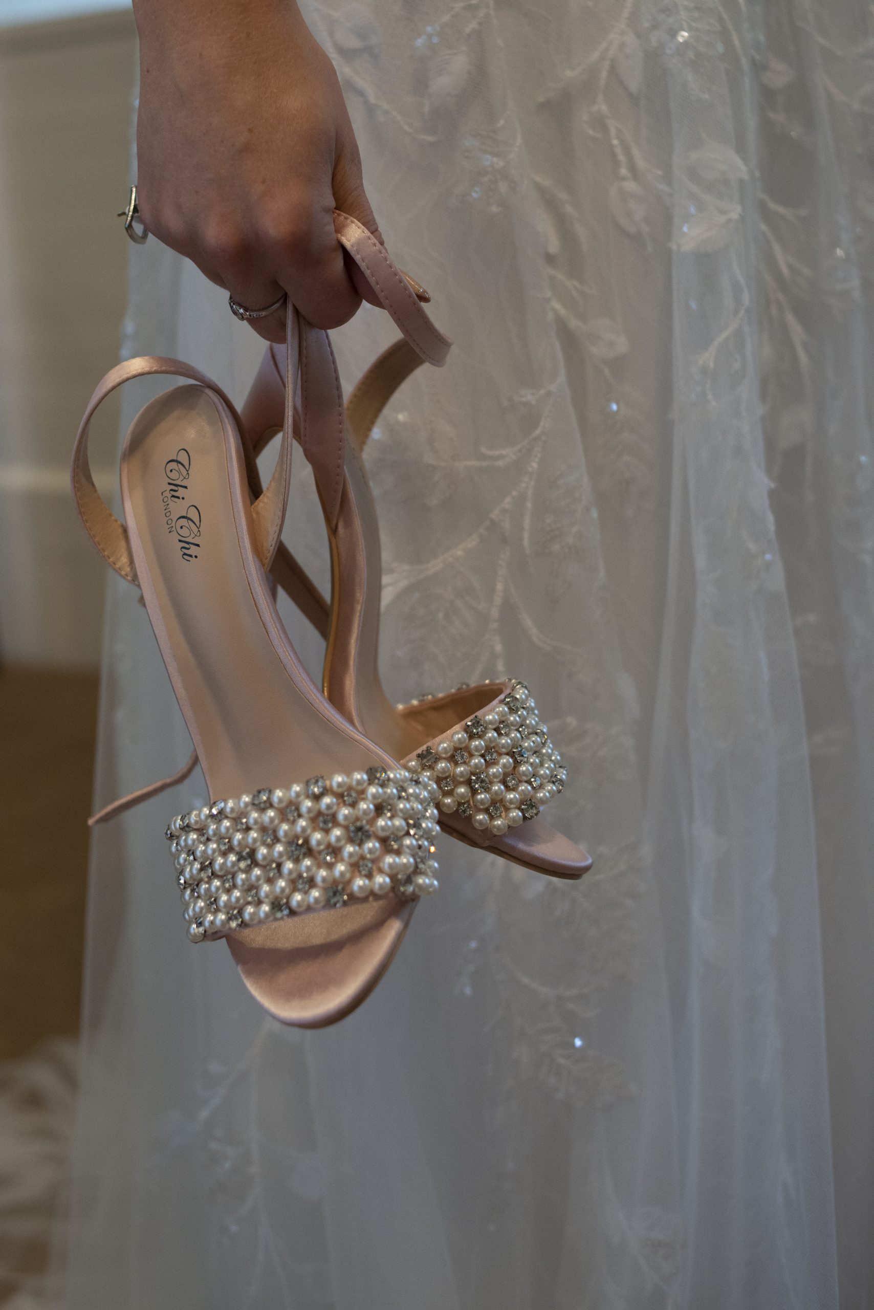 Close up bride holding her shoes