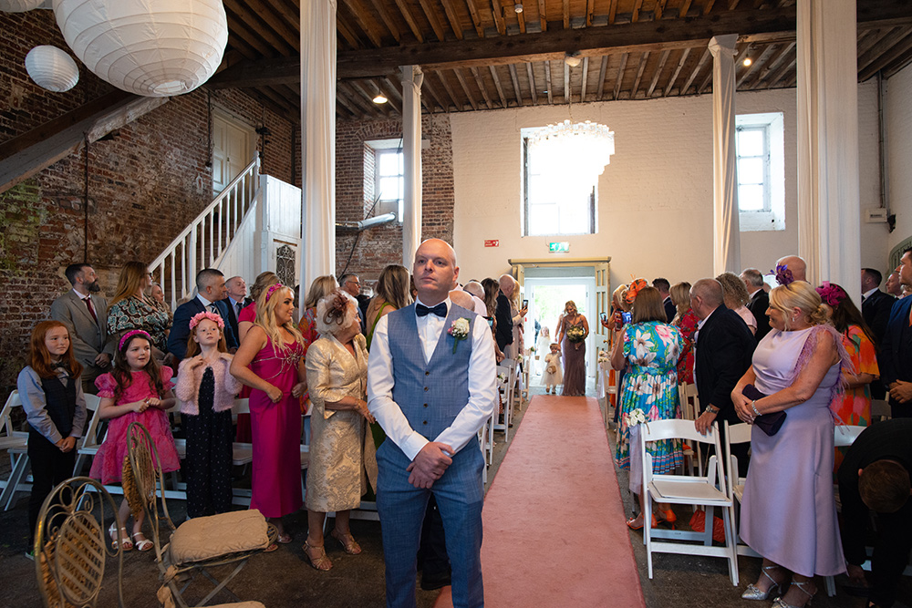 groom waits for his bride to go down aisle at Millhouse Slane wedding