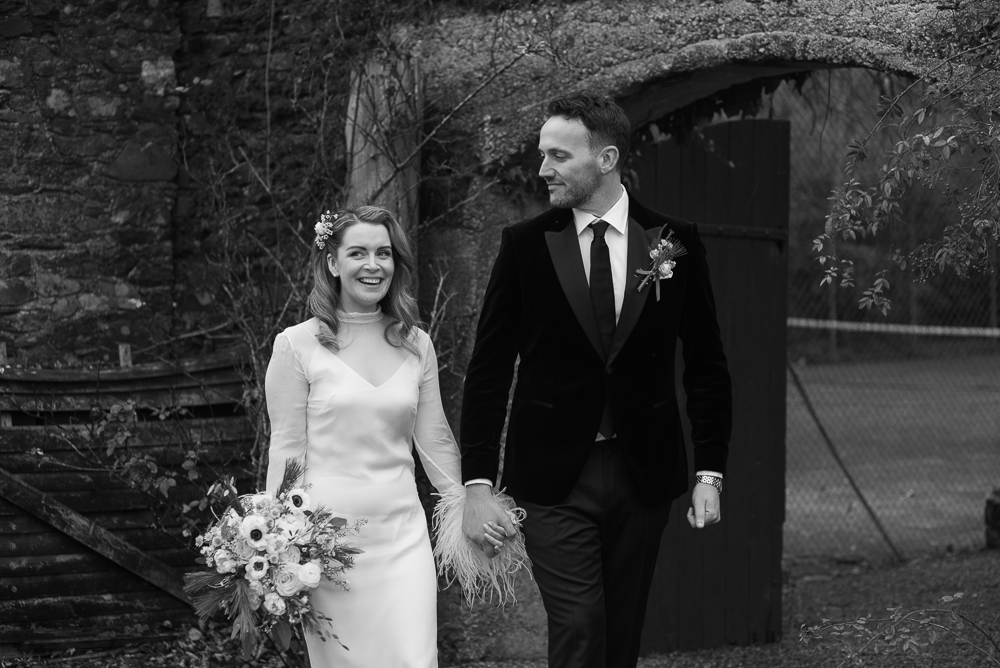 bride and groom walk the grounds at wedding at Rathsallagh House